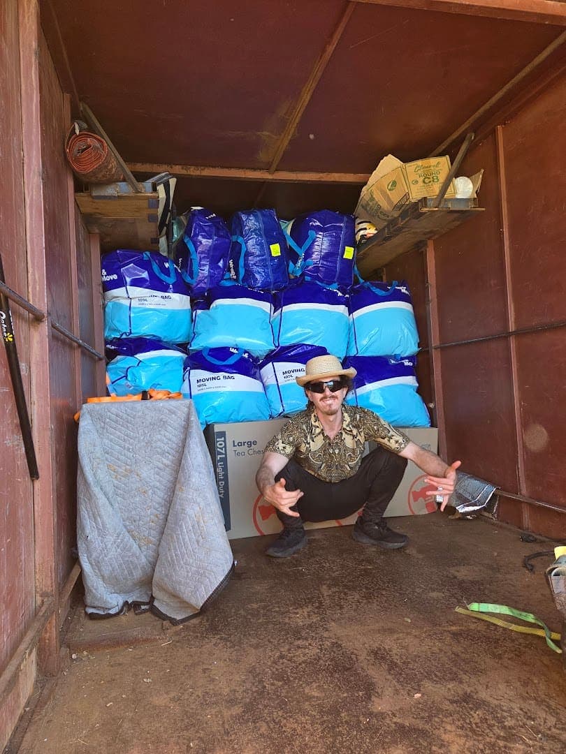 Stacked blue moving bags inside the truck