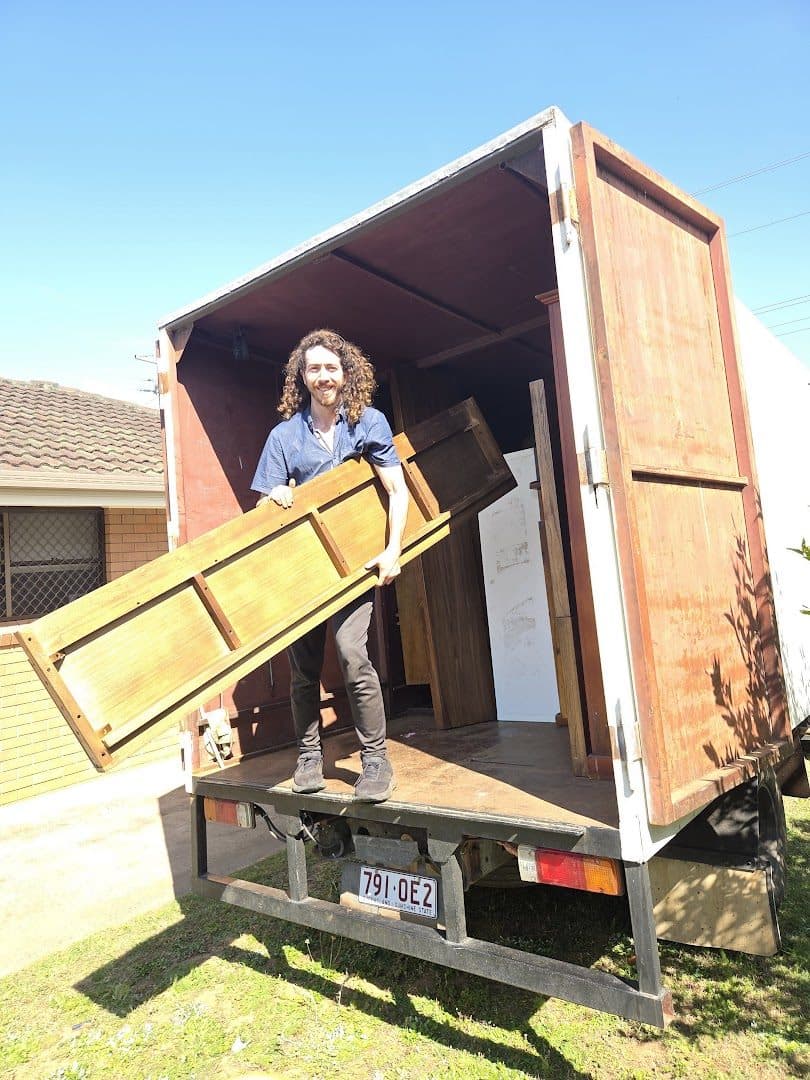 Mayan on the truck tray holding a disassembled timber table top