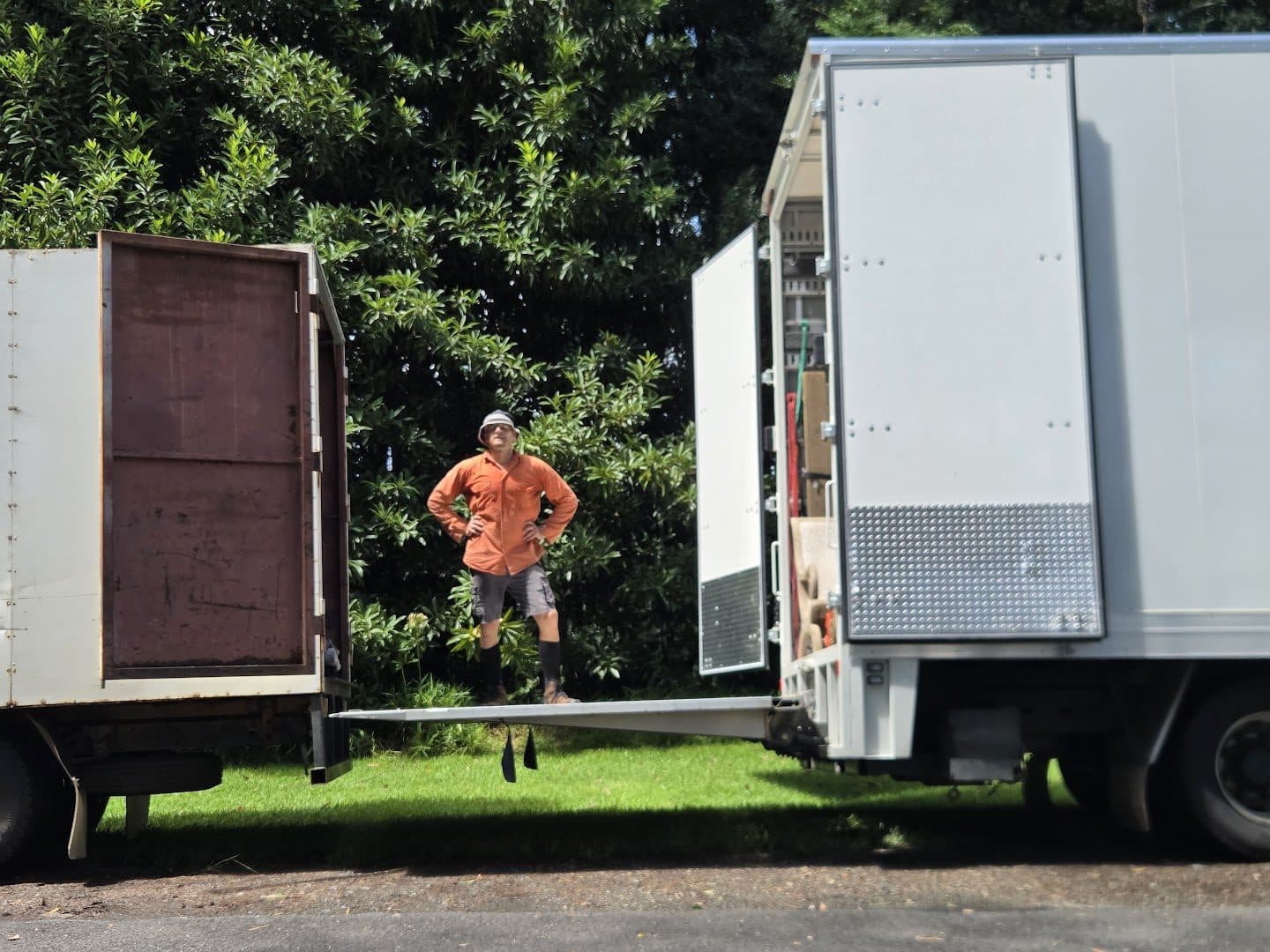 Loading ramp bridging our box truck and another mover's pantech mid-transfer